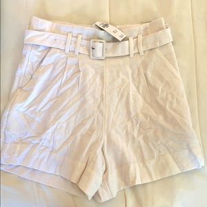 High-waisted white pleat shorts